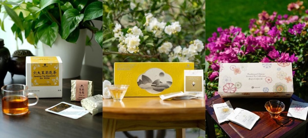 A cozy setup featuring the Jasmine Tea Discovery box from iTeaworld, a cup of brewed tea, and tea cards on a wooden table, surrounded by plants.